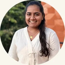 Tanmayi Kirijaji in a white blouse, smiling outdoors